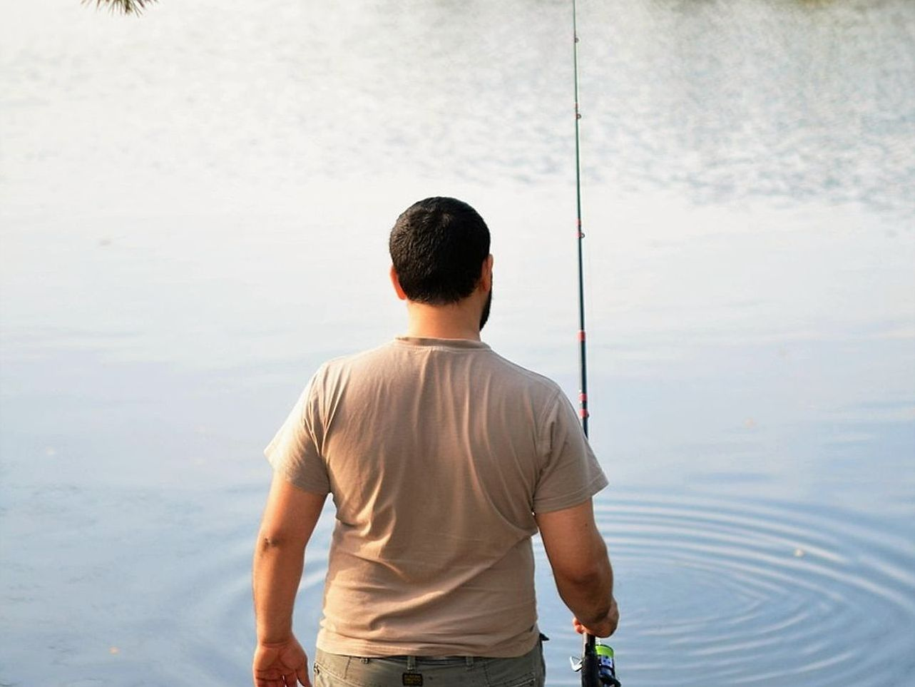 Angler casting into early morning mist